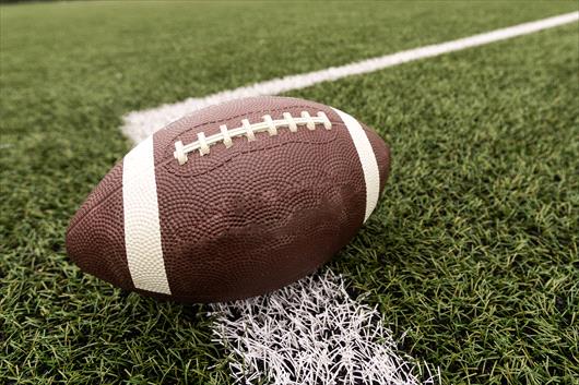 Football on football field turf